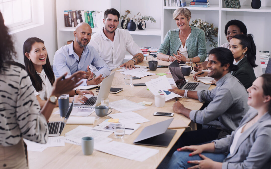 Diverse workforce concept with several diverse employees seated around a conference table.